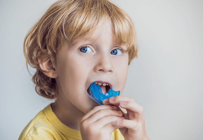 boy playing with mouthguard